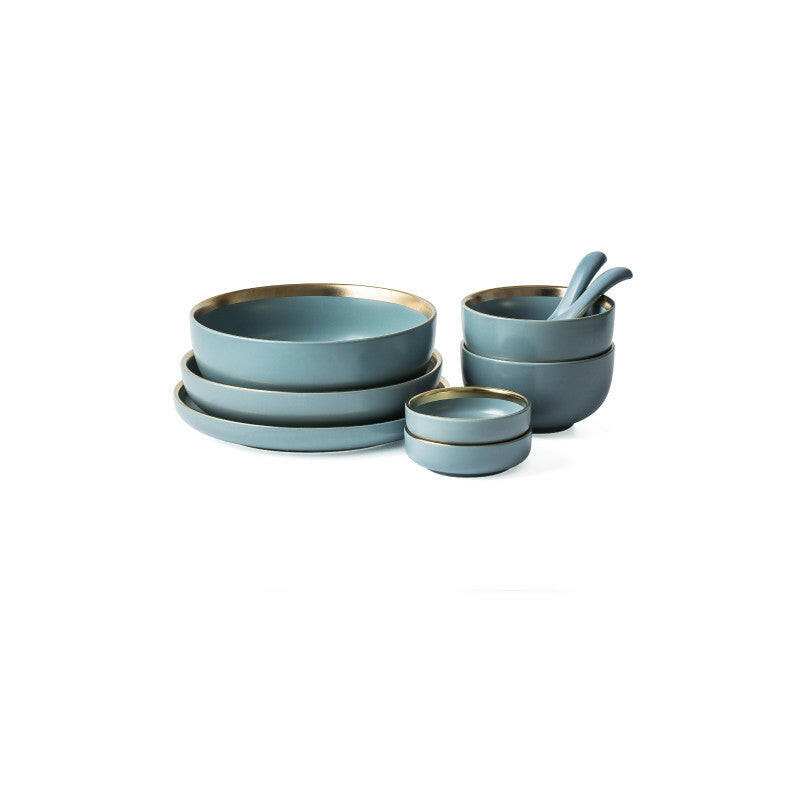 Ceramic tableware set with plates, bowls, and mugs in a blue finish with gold accents, ideal for dining.