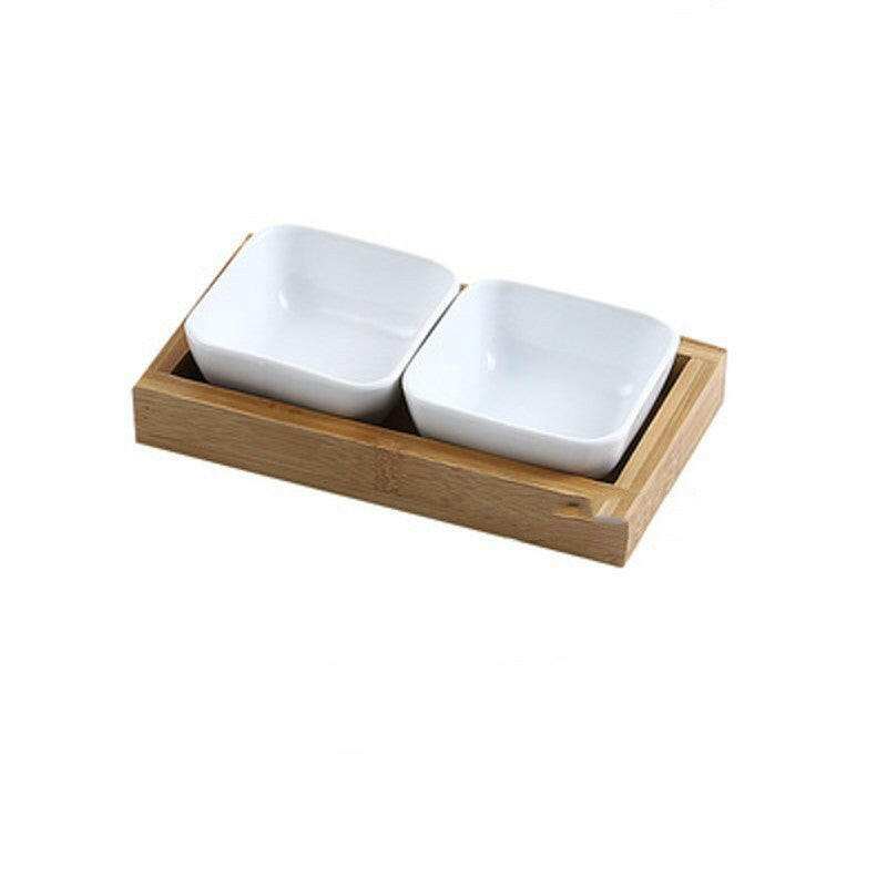 Ceramic bowls with bamboo tray set for stylish food presentation.