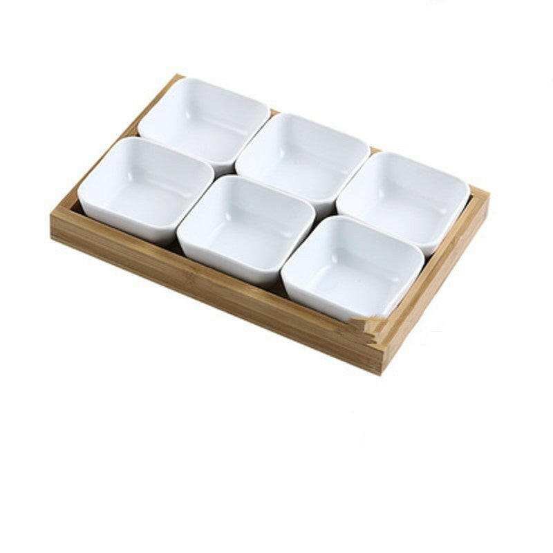 Ceramic bowls with bamboo tray set for serving food.