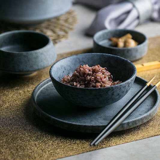 Japanese tableware set, featuring ceramic bowls with minimalist design and natural hues.