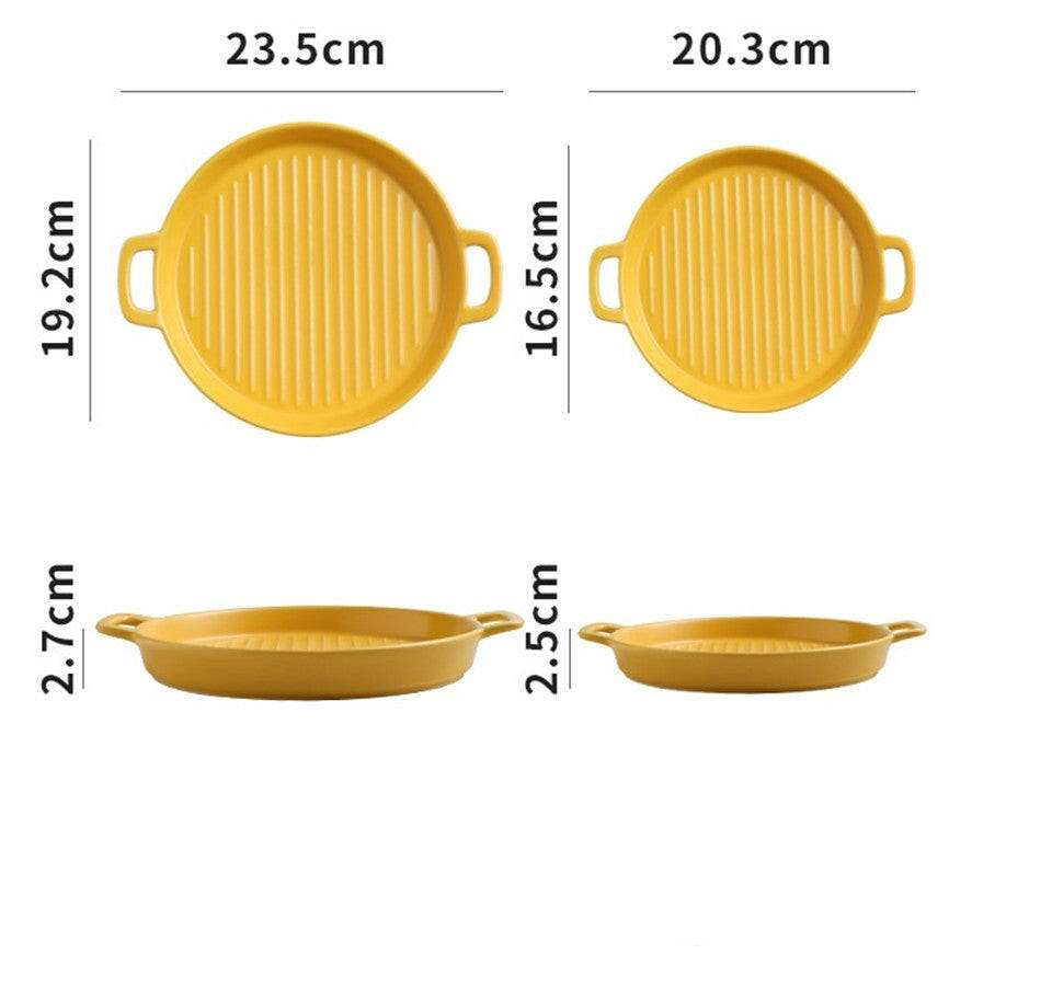 Yellow ceramic bakeware with dual handles, available in sizes 23.5cm and 20.3cm, suitable for oven, microwave, and dishwasher.