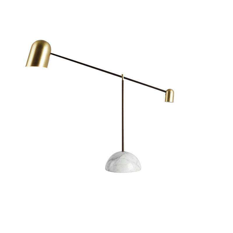 Modern marble table lamp with gold dome and minimalist design.