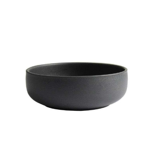 Modern black bowl from dining set, sleek design.