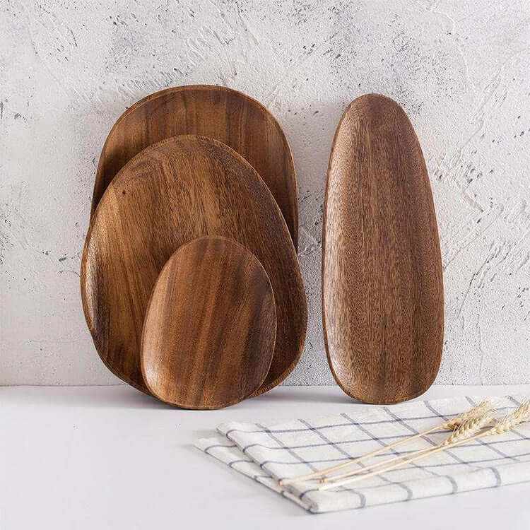 Irregular acacia wood trays with unique shapes and rustic charm, showcasing natural grain and warm tones.
