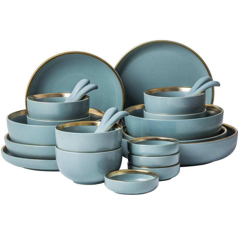 Elegant ceramic tableware set with plates, bowls, and mugs.