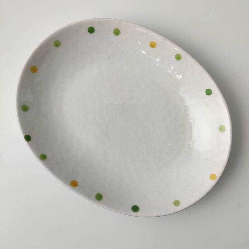 Porcelain Dinnerware Elegant with subtle green and yellow dots.