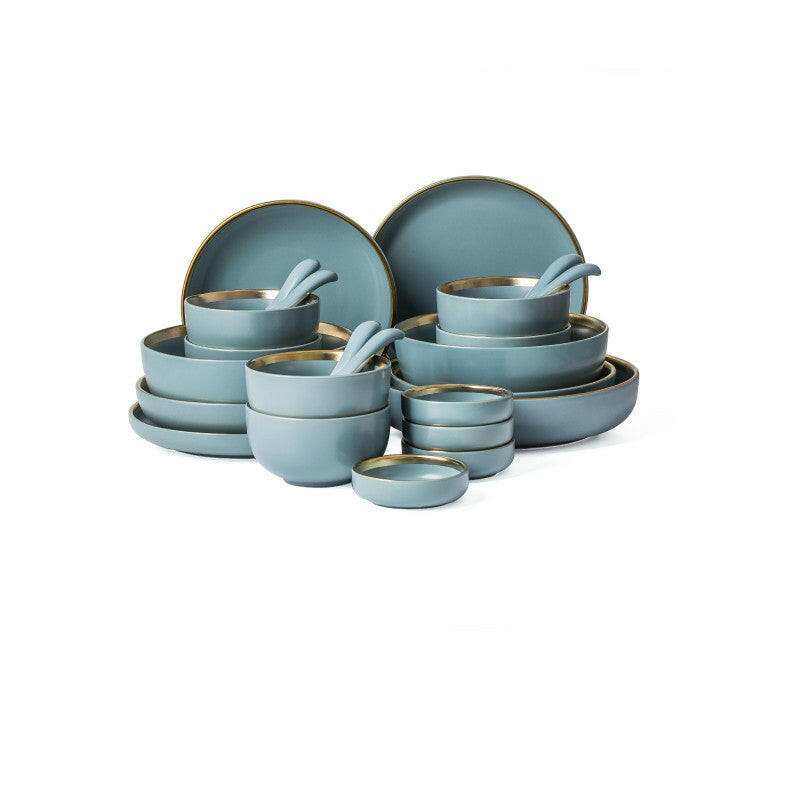Ceramic tableware set with bowls, plates, and mugs in a modern design.