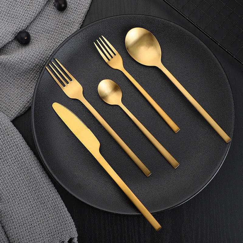 Gold matte stainless steel cutlery set, includes knife, fork, spoon, and teaspoon.