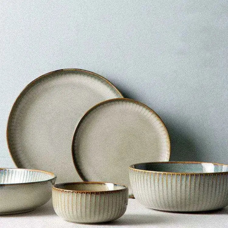 	Stylized ceramic set with contemporary design, featuring bowls and plates.