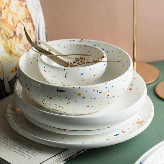 Graceful Dinnerware Set with speckled design including plates and bowls.