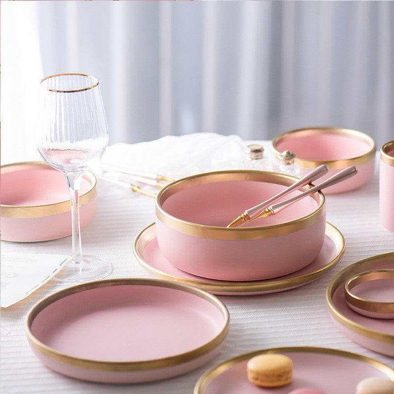 Pink Mood dining set with plates and bowls featuring gold rims.