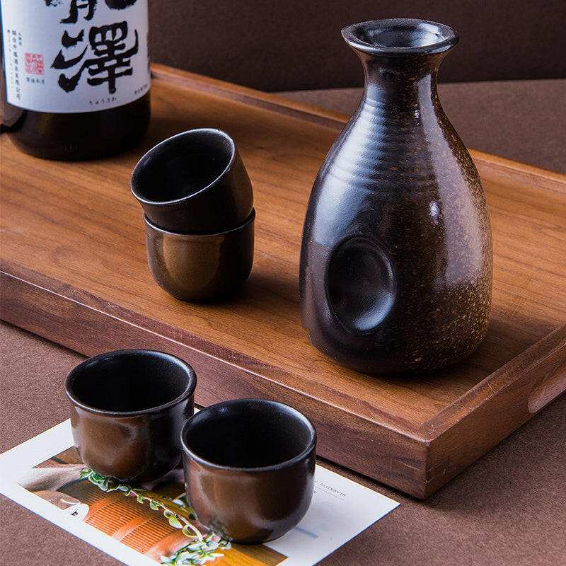 Japanese sake ceramic set with brown sake server and cups.