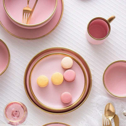 Pink Mood dining set with plates and bowls, with gold accents.