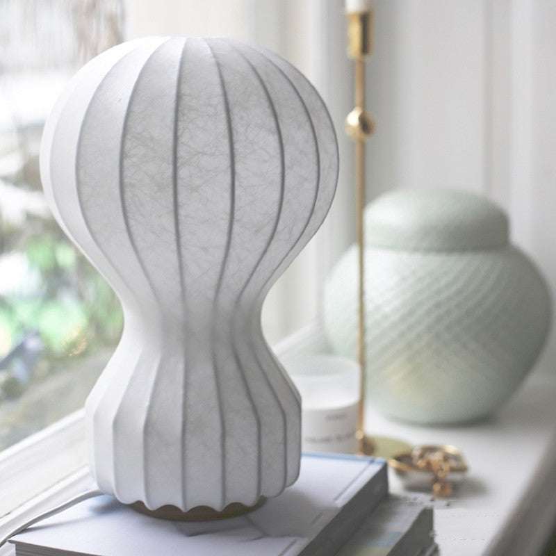 Paper Lamp gourd shape with white balloon and dark base on a windowsill, enhancing contemporary decor.