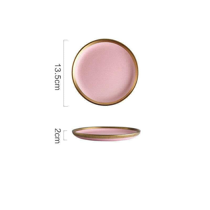 Pink Mood dining set with round plates pink hue, and gold trim.
