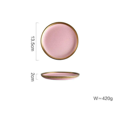 Pink Mood dining set with round plates pink hue, and gold trim.