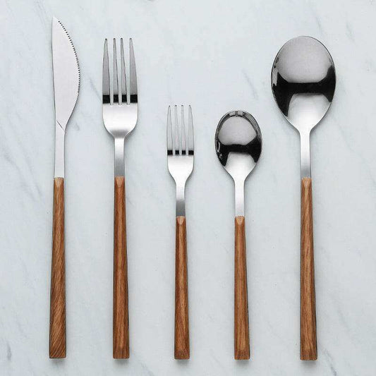 Stainless steel and wooden cutlery set with ergonomic wooden handles on flat surface.