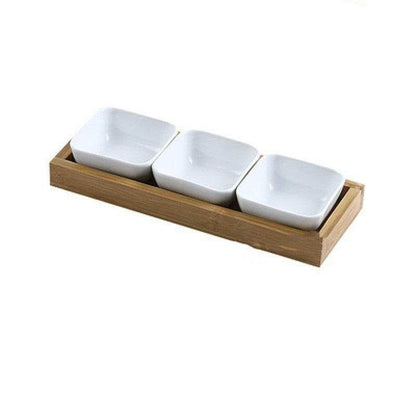 Ceramic bowls with bamboo tray set, ideal for serving food.