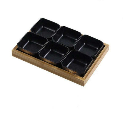 Ceramic bowls set on a bamboo tray for stylish food presentation.