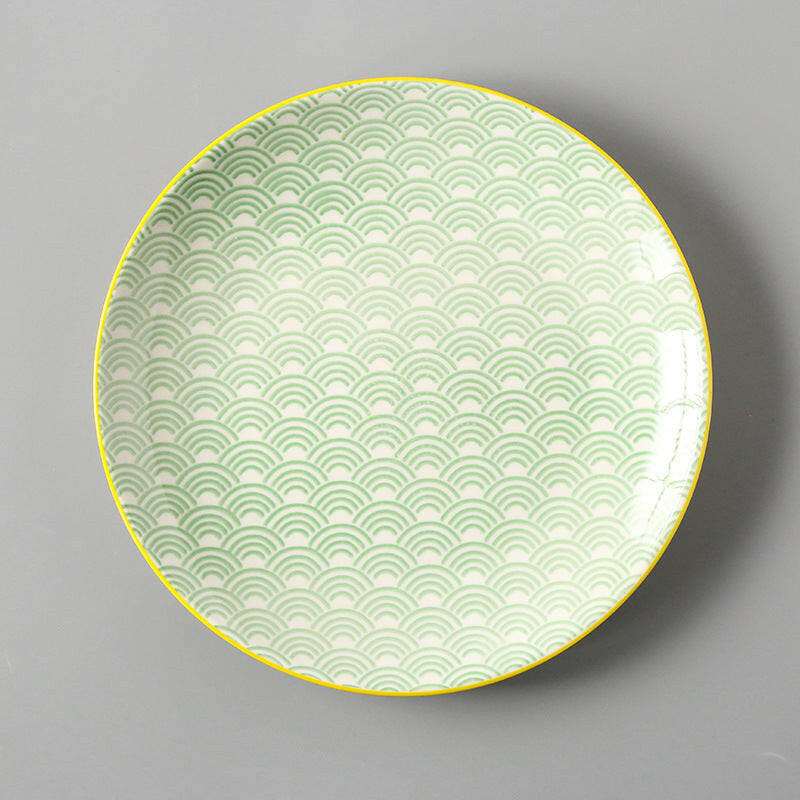 Dishes for Meals Creative plate with green wave pattern and yellow rim.