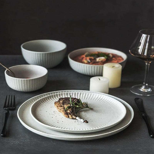 Stylized ceramic dinnerware set with clean, geometric design.