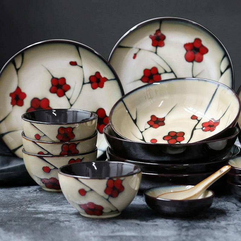 Fine Dining Dishes Japanese floral porcelain set with red blossom motifs on plates and bowls.