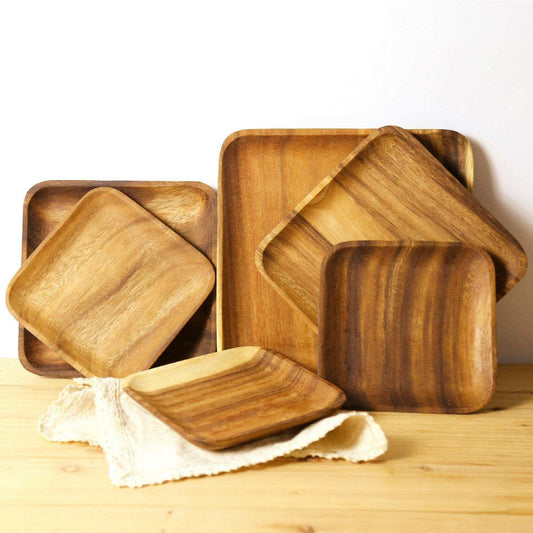 Set of rectangular acacia wood trays showcasing natural grains and warm brown hues, ideal for serving and decor.