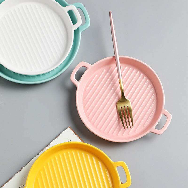 Colorful bakeware plates with handles.