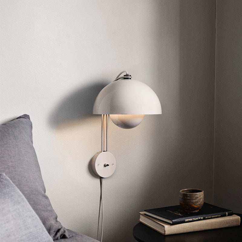 Flowerpot Lamp wall with glossy dome shade providing soft, downward glow.