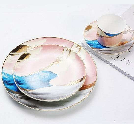 Colorful porcelain hand-painted with abstract patterns featuring tranquil blues, greens, oranges, and yellows on high-quality plates and cup.