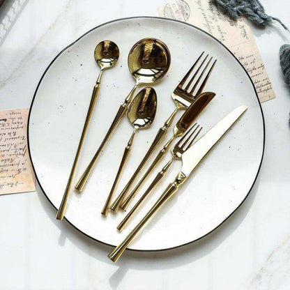 Exquisite stainless steel cutlery set with gold finish.