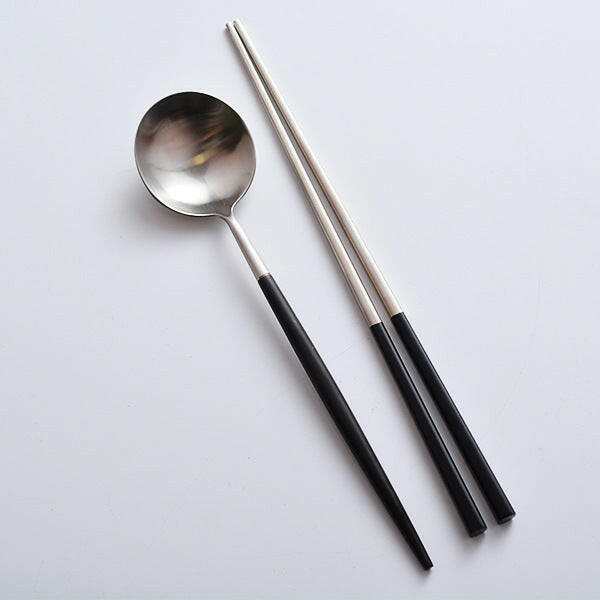 Elegant sushi cutlery set with stainless steel spoon and chopsticks.