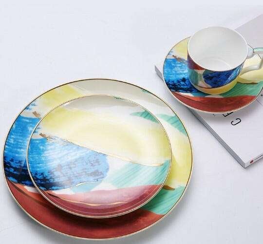 Colorful porcelain hand-painted ceramic watercolor dishes with vibrant abstract design, featuring glossy finish and bold hues in blues, greens, oranges.