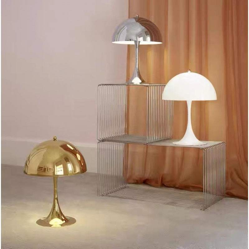 Modern Light - Iconic Danish Lamp gold and silver on display against a warm backdrop.