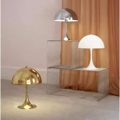 Modern Light - Iconic Danish Lamp gold and silver on display against a warm backdrop.