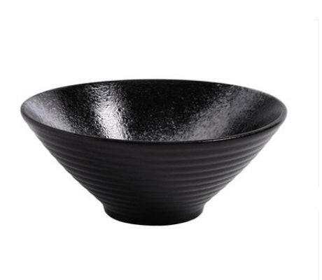 Japanese ceramic ramen bowl with glossy black glaze and textured design, showcasing craftsmanship and functionality.