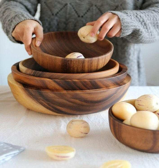 Stacked Acacia wood bowls with rich grain patterns, showcasing durability and natural beauty.