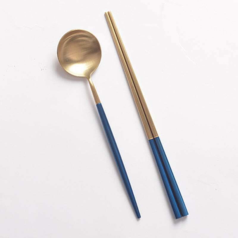 Blue and gold sushi cutlery set with chopsticks and spoon.