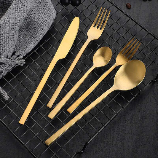 Gold matte stainless steel cutlery, including knives, forks, and spoons, displaying modern elegance and a stylish finish.