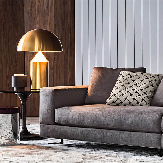 Modern living room with Table Lamp Atollo featuring a hemispherical shade and cylindrical base on a side table next to a grey sofa.