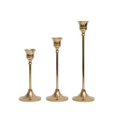 Vintage golden candle holder set with elegant design and shiny finish.