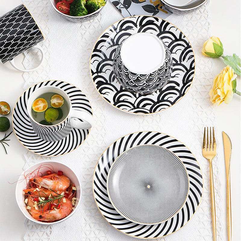 Modern geometric ceramic dishes with black and white patterns.