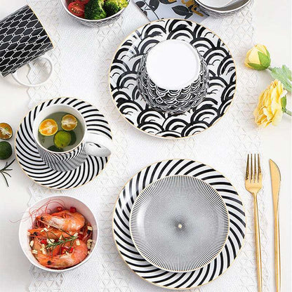 Modern geometric ceramic dishes with black and white patterns.