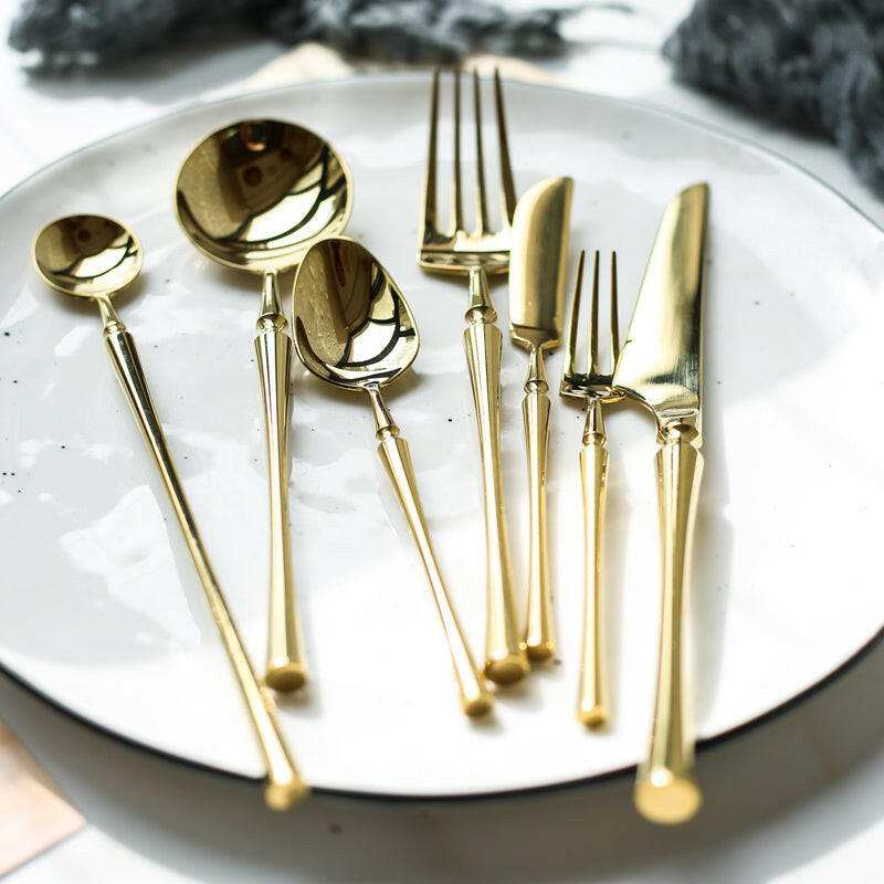 Exquisite stainless steel cutlery set with gold finish.