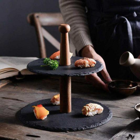 Rustic multilayer board with black stone and wood design for elegant food presentation.