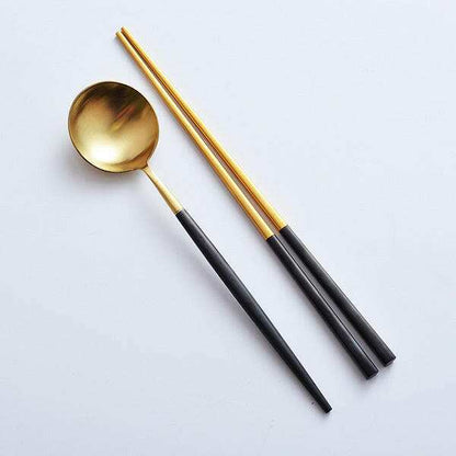 Elegant sushi cutlery set including gold-toned spoon and chopsticks, designed for sushi dining.