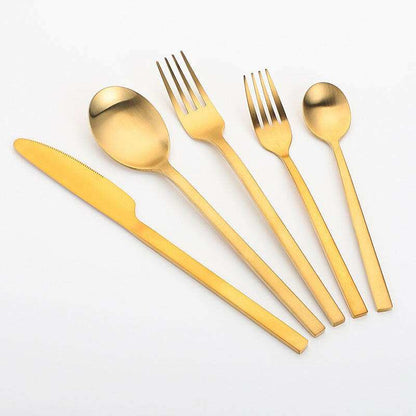 Matte stainless steel cutlery set in gold finish including knife, fork, soup spoon, and teaspoon for modern dining.