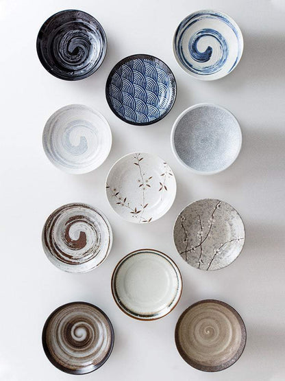 Retro Japanese ceramic plates with diverse textures and patterns, ideal for decor and art display.