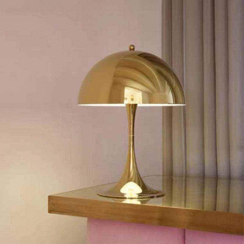 Modern Light - Iconic Danish Lamp on a table, featuring a sleek gold finish and modern design.