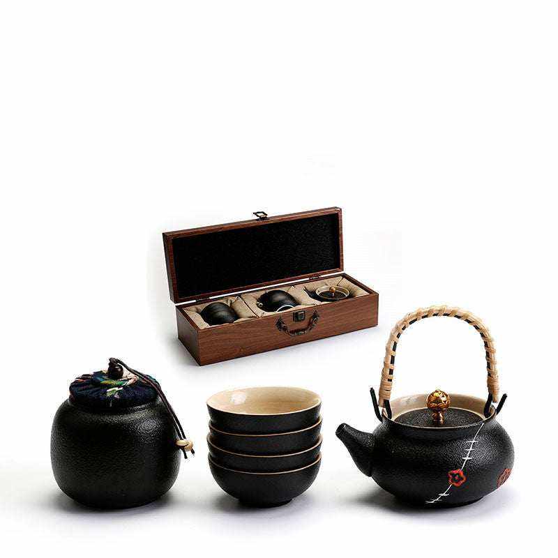 Traditional Japanese tea set with elegant textured teapot, teacups, and fabric-wrapped container.